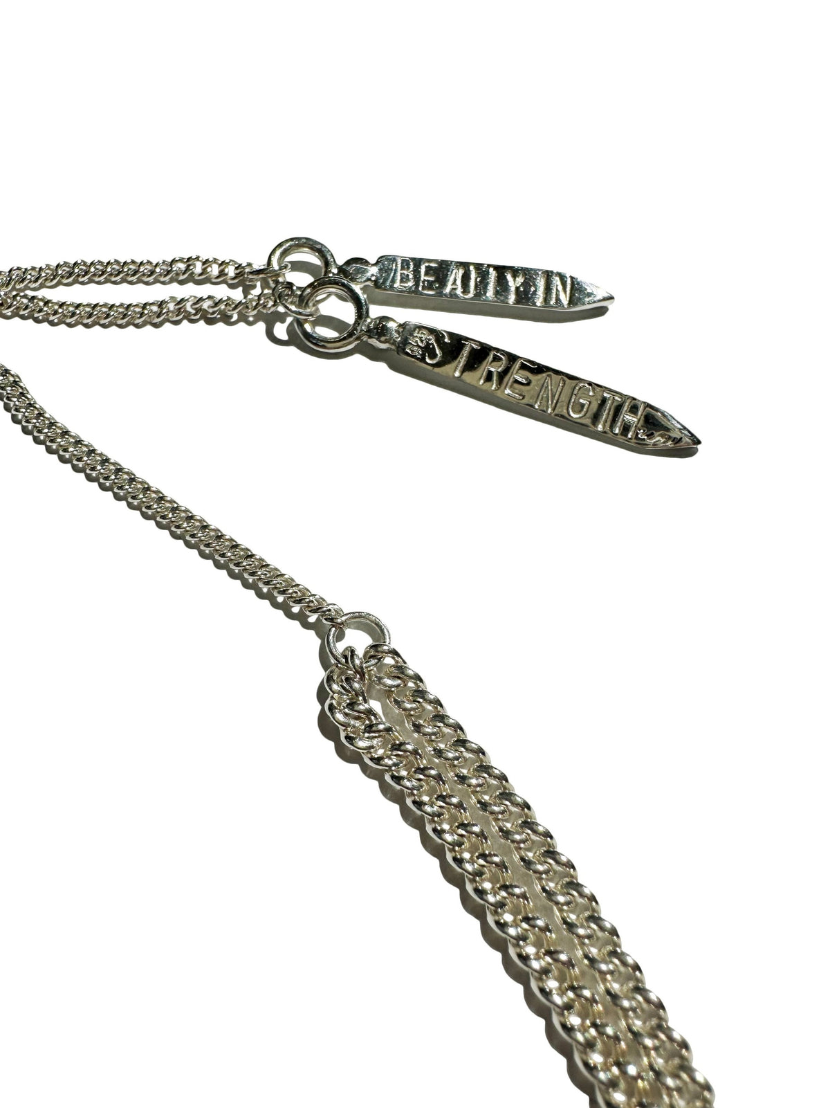 Custom tag for slider bead reading "beauty in strength"