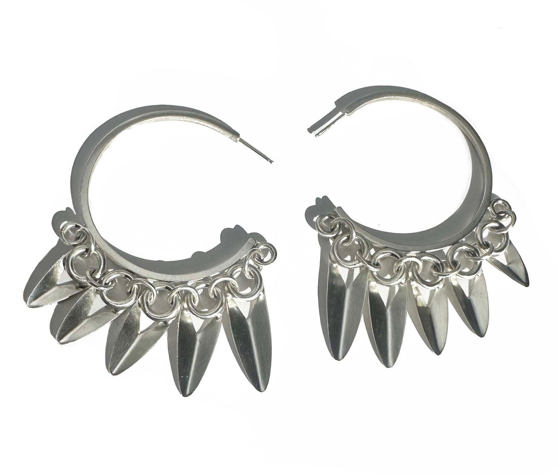 Silver hoop earrings with spike-like / leaf-like designs on a white background

Brushed sterling silver

Measures 1 3/4" across, longest petal measures 1 1/4"