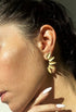 Gold leaf-shaped earrings on model

Brushed 14kt gold over sterling silver

Measures approximately 1 1/4” x 1/2”